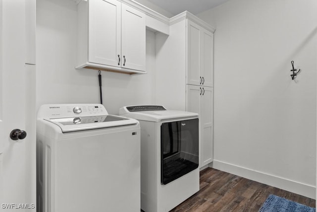 laundry room with cabinets, washer and dryer, and dark hardwood / wood-style flooring