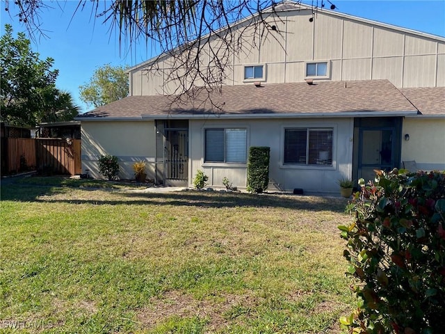 back of property featuring a lawn