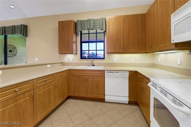 kitchen featuring sink, light tile patterned floors, and white appliances