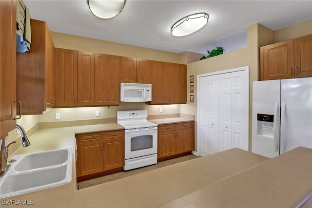 kitchen featuring sink and white appliances