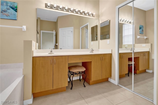 bathroom with tile patterned floors, vanity, and a bath