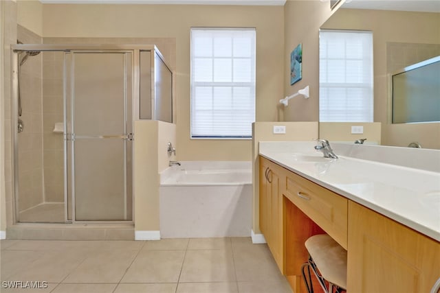 bathroom with tile patterned floors, independent shower and bath, and vanity