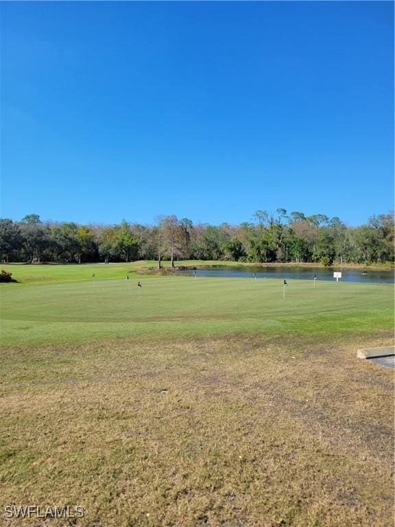 view of property's community featuring a water view and a yard