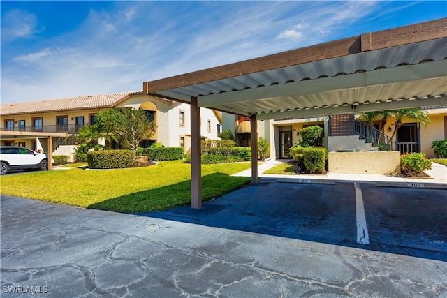 view of car parking with a carport and a lawn