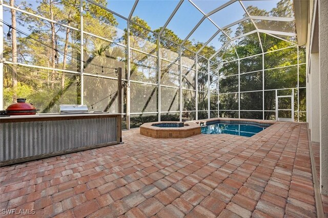 view of pool featuring an in ground hot tub, a lanai, and a patio