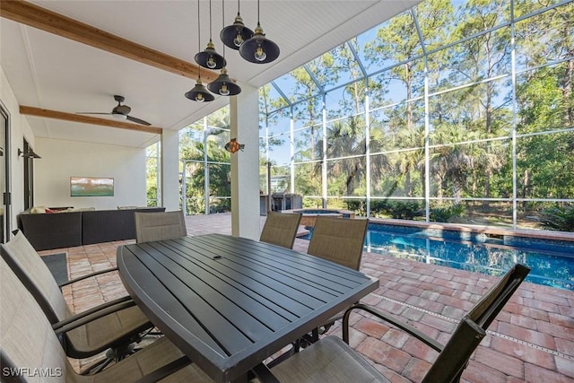 view of patio featuring a swimming pool with hot tub, ceiling fan, and glass enclosure