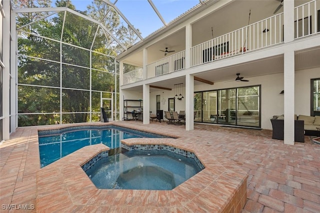 view of pool featuring a lanai, ceiling fan, a patio, an outdoor living space, and an in ground hot tub