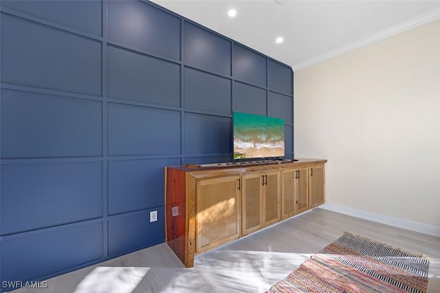 interior space featuring light hardwood / wood-style flooring and ornamental molding