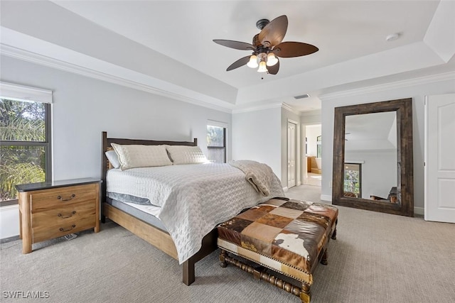 4221 5th Ave NW, Naples, FL 34119 - bedroom with light colored carpet, multiple windows, a raised ceiling, ceiling fan, and crown molding