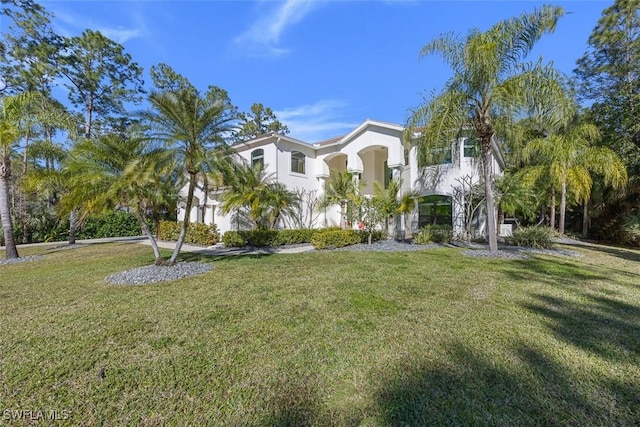 view of front facade featuring stucco siding and a front lawn