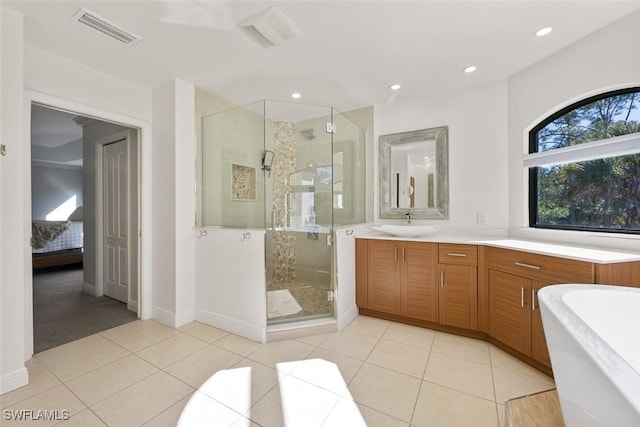 bathroom with vanity, tile patterned floors, and plus walk in shower