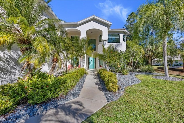 mediterranean / spanish-style home with a front lawn