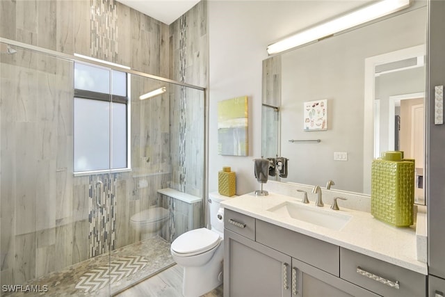 bathroom featuring vanity, an enclosed shower, and toilet