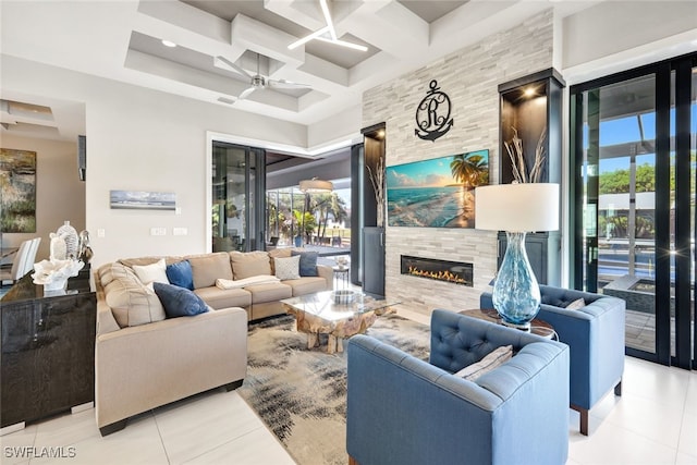 tiled living room featuring coffered ceiling, plenty of natural light, a tile fireplace, and beamed ceiling