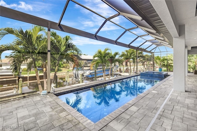 view of pool featuring a lanai, a dock, a patio, and an in ground hot tub