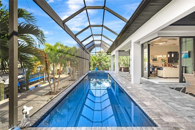 view of swimming pool with a lanai and a patio area