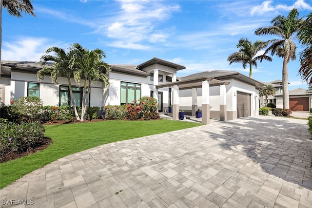 view of front of property featuring a garage and a front lawn