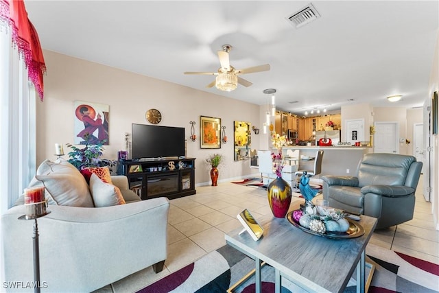 tiled living room with ceiling fan