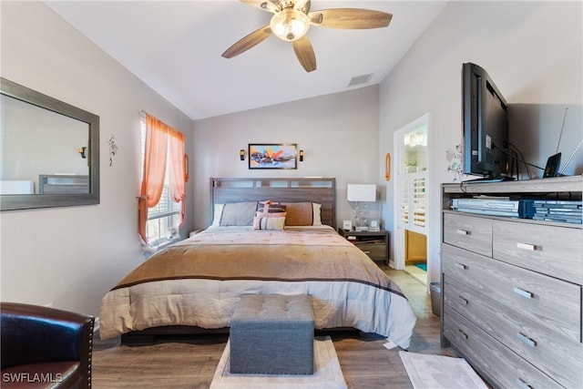 bedroom with hardwood / wood-style flooring, ceiling fan, and lofted ceiling