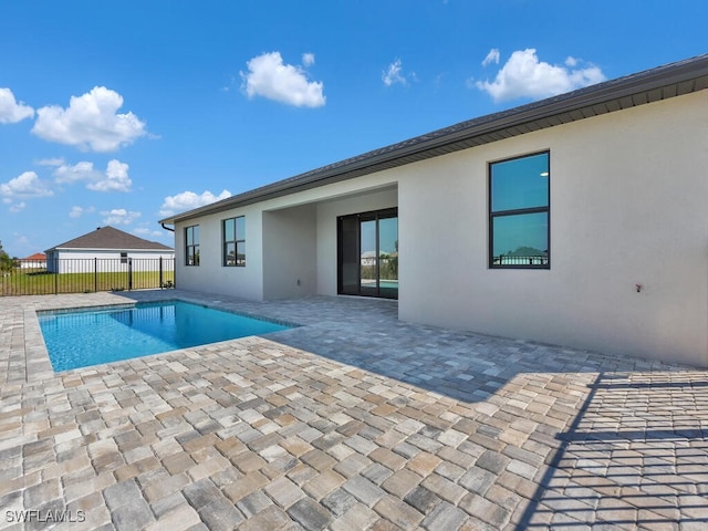 view of swimming pool with fence, a fenced in pool, and a patio