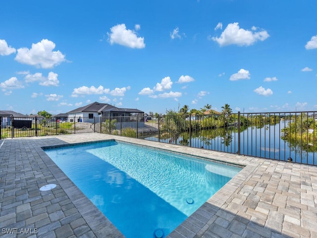 view of swimming pool featuring a fenced in pool, a water view, a patio, and fence