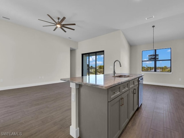 kitchen with open floor plan, gray cabinets, a sink, and dark wood finished floors