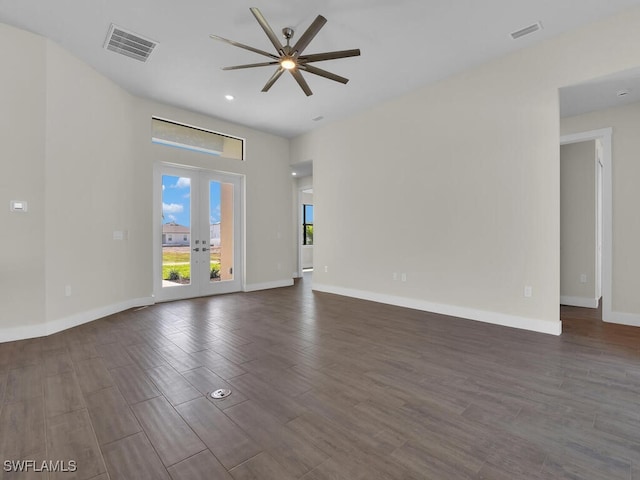 unfurnished room with baseboards, visible vents, dark wood-style flooring, and french doors