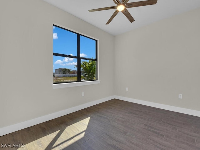 unfurnished room with a ceiling fan, baseboards, and wood finished floors