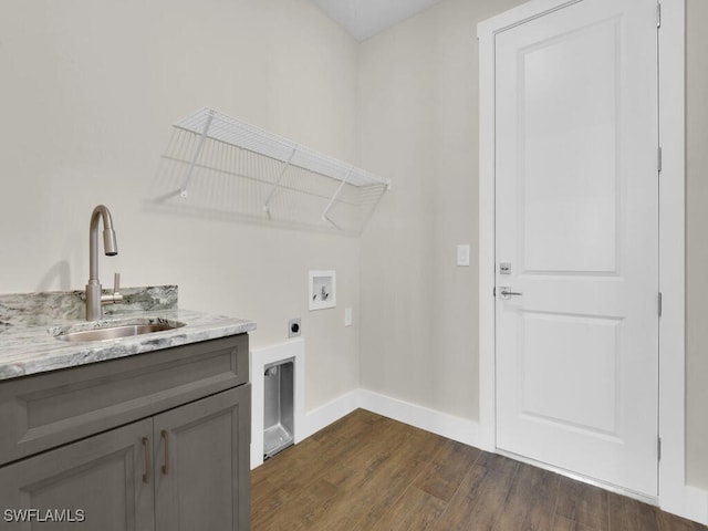 laundry area with baseboards, dark wood finished floors, a sink, hookup for a washing machine, and electric dryer hookup