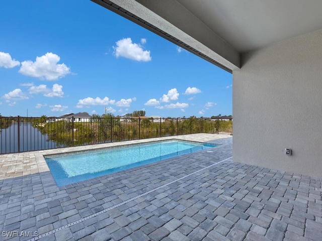 view of swimming pool featuring fence, a fenced in pool, and a patio