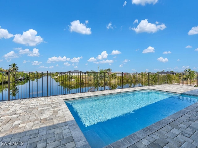 view of swimming pool featuring a patio, a water view, fence, and a fenced in pool