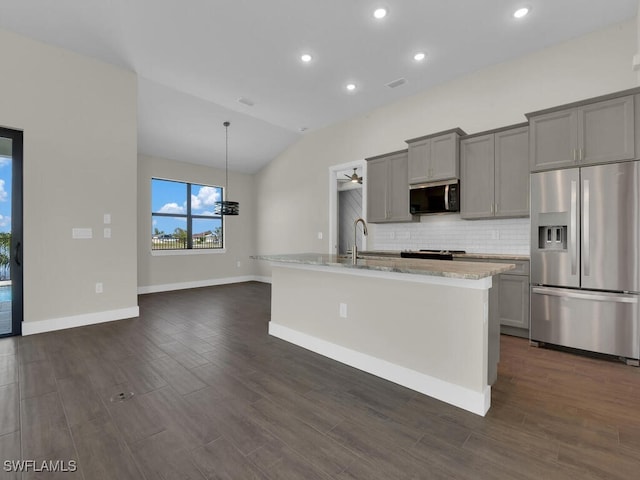 kitchen with tasteful backsplash, gray cabinets, stainless steel appliances, and dark wood-type flooring