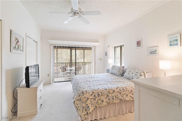 bedroom with ceiling fan, light carpet, a textured ceiling, and access to outside