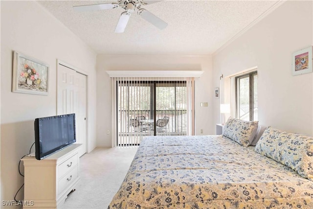 bedroom featuring light colored carpet, a textured ceiling, a closet, ceiling fan, and access to exterior