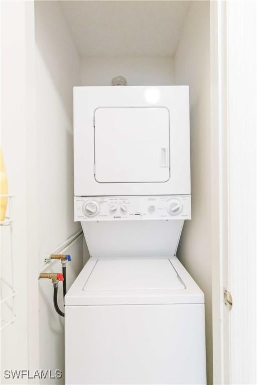 washroom with stacked washer and dryer