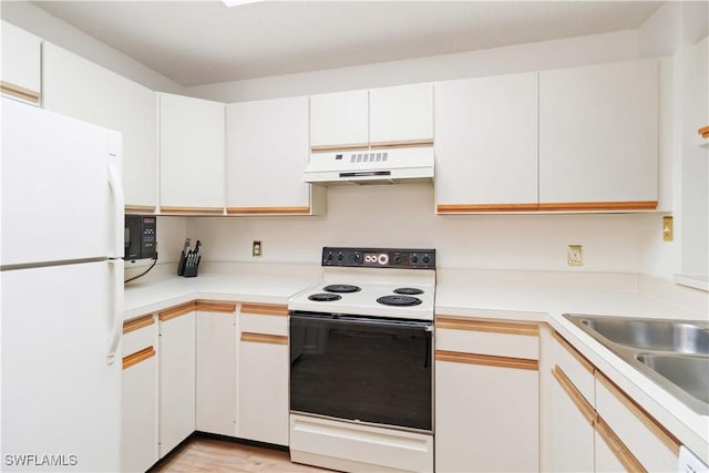 kitchen featuring white cabinetry, sink, white appliances, and light hardwood / wood-style floors