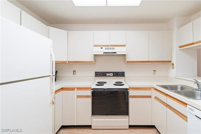 kitchen featuring white cabinetry, sink, and white appliances