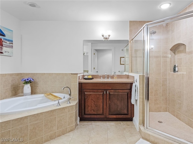 bathroom featuring tile patterned floors, independent shower and bath, and vanity