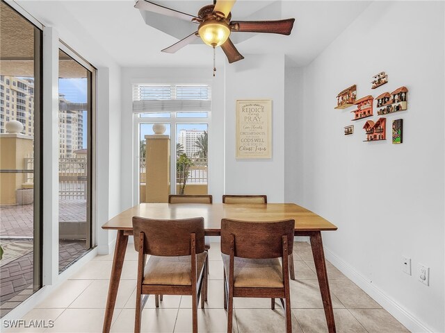 tiled dining area with ceiling fan