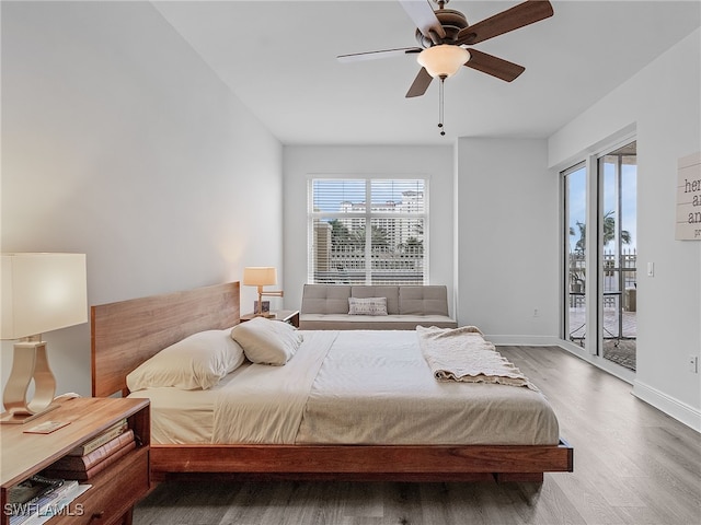 bedroom with hardwood / wood-style flooring, ceiling fan, and access to exterior