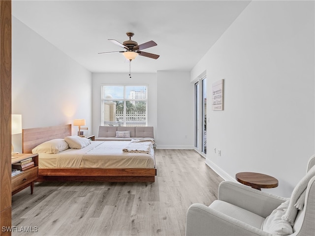 bedroom with light hardwood / wood-style flooring and ceiling fan