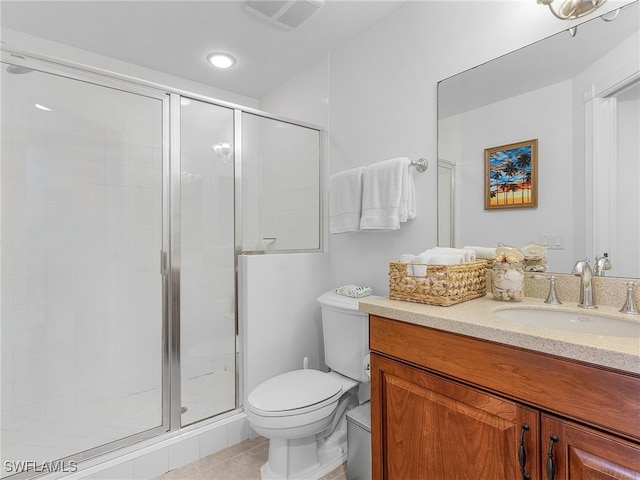 bathroom with vanity, tile patterned floors, a shower with door, and toilet