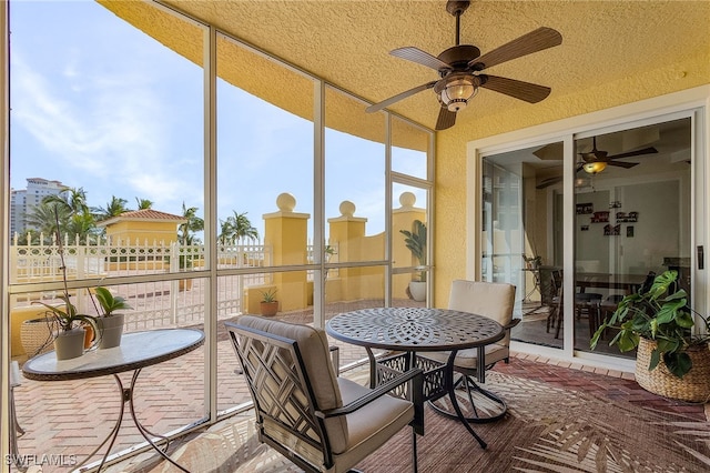 sunroom featuring ceiling fan