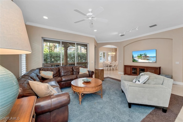 living room featuring crown molding, rail lighting, and ceiling fan with notable chandelier