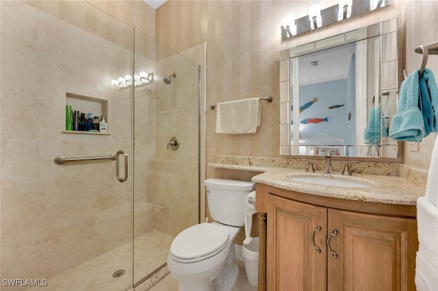 bathroom with vanity, a shower with shower door, and toilet