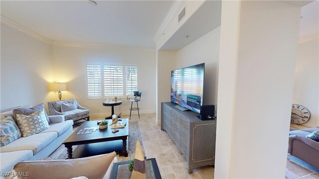 living room featuring visible vents, stone finish floor, baseboards, and ornamental molding