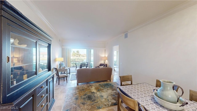 dining area with stone tile flooring, visible vents, and ornamental molding