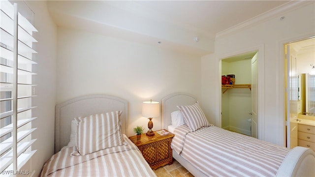 bedroom featuring a closet, a walk in closet, and ornamental molding