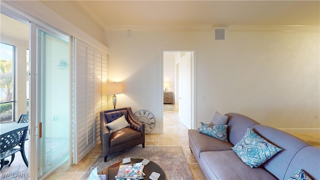 living area featuring crown molding, baseboards, and visible vents