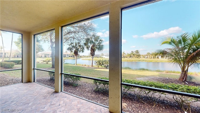 unfurnished sunroom with a water view